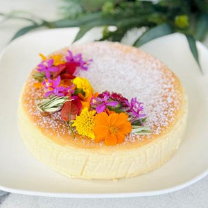 Vanilla Baked Cheesecake topped with edible flowers